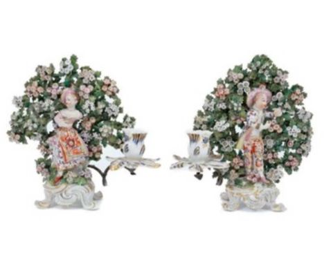 Pair of Bow 'New Dancer' figure candlesticks, circa 1765, with bocage decoration behind each figure, standing on scrollwork b