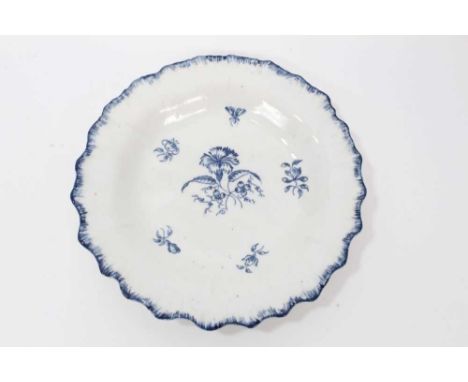 A rare Caughley blue printed Gillyflower pattern plate, circa 1780-85, with feathered edge, mark to base, 21.5cm diameterCond