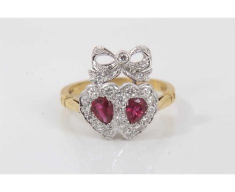 Victorian style ruby and diamond sweetheart ring with two hearts surmounted by a ribbon with two pear cut rubies surrounded b