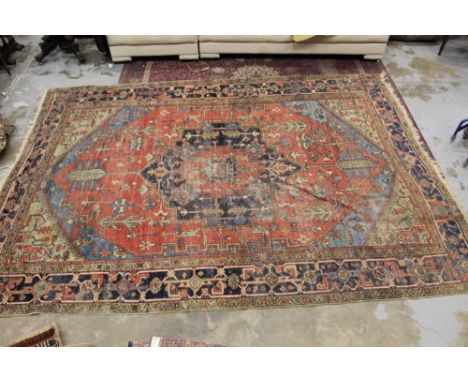 Antique Heriz carpet, with central radiating medallion in brick red ground with main vine-work border, 400 x 275cmCondition r