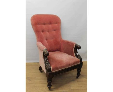 William IV button back mahogany armchair, with lappet carved showwood frame on turned legs annd castors