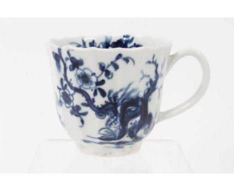 A Worcester blue and white coffee cup, circa 1758, of faceted form, decorated with the Prunus Root pattern, painter's mark to