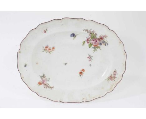 A Chelsea scalloped oval dish, circa 1755, polychrome painted with floral sprays, brown-painted rim, red anchor mark to base,