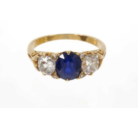 Late Victorian diamond and sapphire three stone ring with an oval mixed cut blue sapphire measuring approximately 7.1mm x 6.6