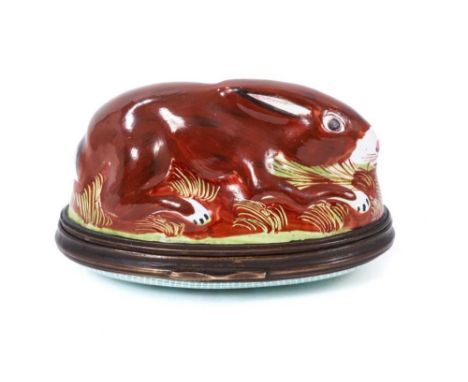 18th century South Staffordshire enamel bonbonnière, in the form of a brown rabbit, circa 1765-70 with raised floral spray to