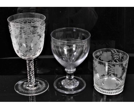 An early 19th century glass rummer, engraved with initials, a tumbler engraved with garden tools and other symbols with lemon