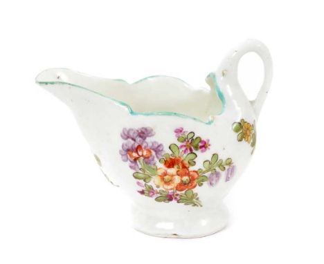 A Lowestoft 'Dolphin Ewer' cream boat, circa 1780, painted in the 'Tulip Painter' style with floral sprays, blue-lined rim, 7