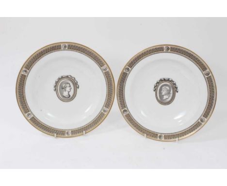 A pair of Vienna plates, circa 1780, painted in Neoclassical style with portrait busts and a Greek key border, beehive marks,