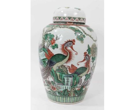 Chinese famille verte vase and associated cover, circa 1900, decorated with a pair of phoenixes amongst flowers and rockwork,