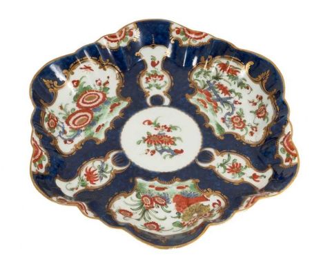 A Worcester hexagonal teapot stand, circa 1772, painted in Kakiemon style on a blue scale ground with gilt highlights, cresce