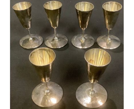 A set of six silver toasting cups, each bearing crest, Sheffield 1945, 208g 