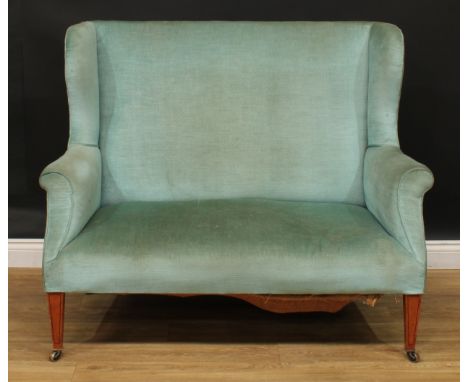 A George III Revival satinwood wingback sofa, tapered square legs, brass casters, 102cm high, 124.5cm wide, the seat 97cm wid