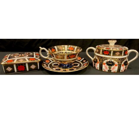 A Royal Crown Derby Imari palette 1128 pattern rectangular trinket box and cover, first quality;  an 1128 cup and saucer, an 