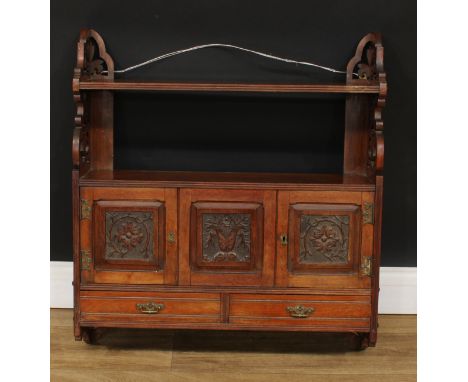 A late Victorian walnut wall-hanging cabinet, rectangular shelf with shaped and pierced end supports above a pair of carved p