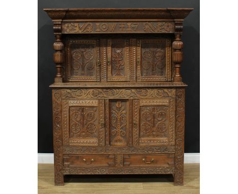 A 17th century design oak duodarn, outswept cornice above three panel doors, the projecting base with two further panel doors