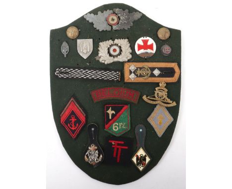 Board of WW2 German and other Badges: WW2 German cap wreaths, army shooting badge, shoulder boards and French cloth and fob b