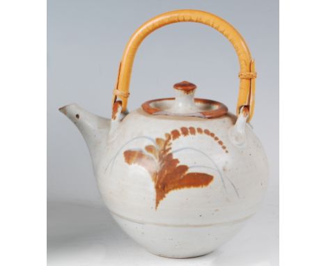 David Leach (1911-2005) - a studio pottery teapot and cover, having a bamboo swing handle and short tapering spout, with oppo