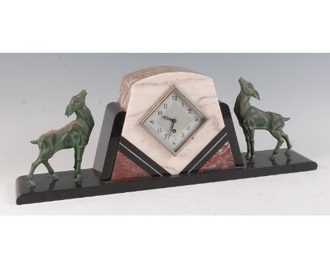 A French Art Deco polished black slate and variegated marble mantel clock, having a silvered lozenge dial, with opposing gree