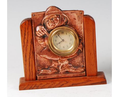 An early 20th century embossed copper novelty bedside alarm clock, decorated as a standing policeman pointing towards the ins