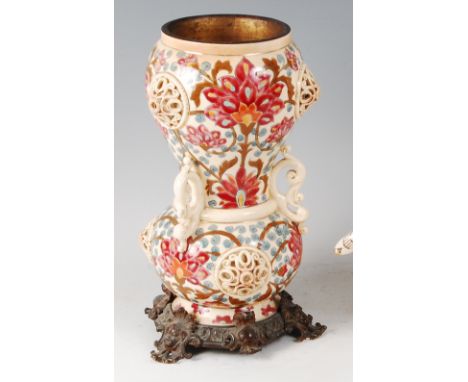 Zsolnay Pecs - a pottery oil lamp base, of bulbous upper and lower form, with pierced scroll handles, typically underglaze fl