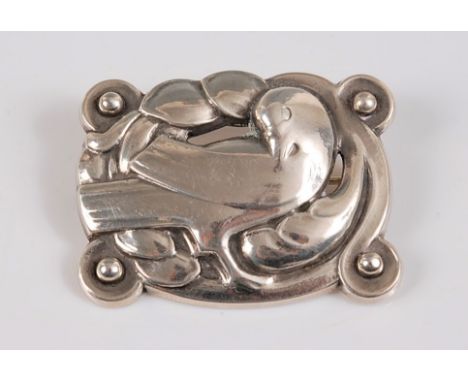*Georg Jensen (1866-1935) - a silver Dove brooch, the stylised repoussé dove sat amongst leaves, stamped to reverse 'Sterling