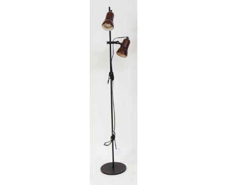 A 1970s Danish twin-light floor lamp, having rotating and adjustable brown painted dome shades, on black painted rod column t
