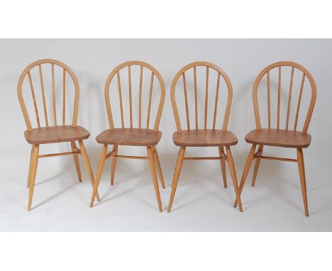 A set of four 1960s Ercol blond elm and beech stickback kitchen chairs, each on turned supports with high stretchers, w.39.5c