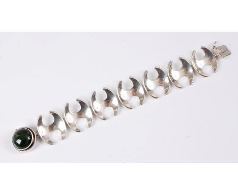 *Georg Jensen (1866-1935) - a silver and jade bracelet by Henning Koppel (1918-81), the round jade cabochon collet mounted wi