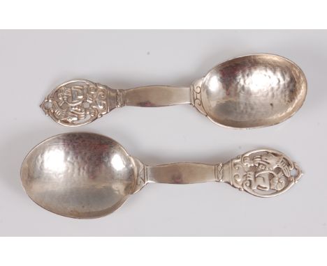 Sybil Dunlop - a pair of hand-crafted 1930s silver spoons, each with hammered bowls and pierced and stylised terminals, Londo