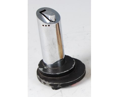 An Art Deco chrome refillable table lighter, of cylindrical form, to stepped lacquered cast metal base, h.12cm