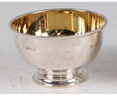 A 1970s silver circular pedestal sugar bowl by Garrard &amp; Co, having a gilt wash interior, raised on stepped foot, London 