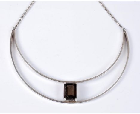 A Scottish silver and smokey quartz necklace, the open crescent moon shape set to centre with a step cut smokey quartz, appro