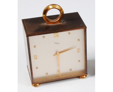 A 1970s Imhof gilt brass cased double-sided bedside alarm clock, with loop handle and of square form, with opposing brushed s