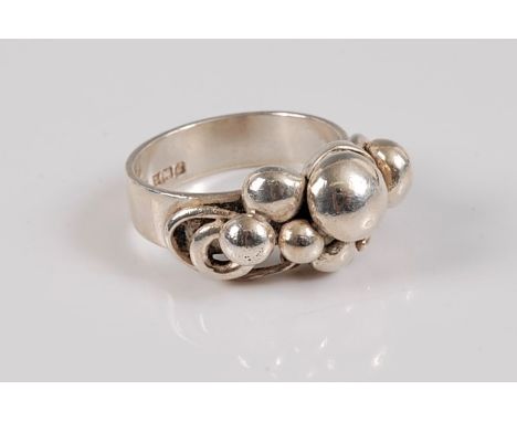 *A mid 20th century silver Georg Jensen style ring, set with beads of differing sizes set among curls of silver, with a 5mm w