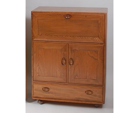 An Ercol light elm Windsor 469 drinks cabinet, having hinged fall-front over twin cupboard doors to single long lower drawer,