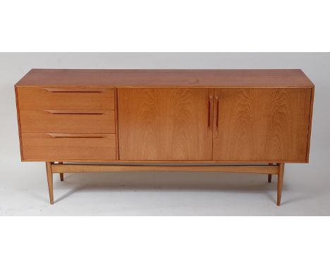 A 1960s McIntosh teak sideboard, having twin cupboard doors and three conforming drawers, each with integral long blind handl