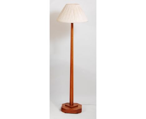 An Art Deco figured walnut standard lamp, having an octagonal tapering column to stepped and chamfered base, h.156cm (excludi