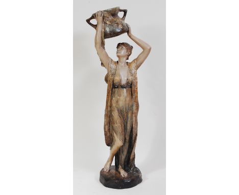 Ferdinand Grohs for Goldscheider - a large painted terracotta figure of a water-carrier, modelled as a standing female in flo