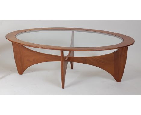 A G-Plan teak Surfboard oval coffee table, having a glass inset top, h.42cm, w.122.5cm, d.66cm. Stands slightly uneven.Teak i