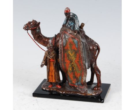 After Franz Bergmann - a cold painted spelter model of a camel table lighter, modelled as two rug traders, raised on faceted 