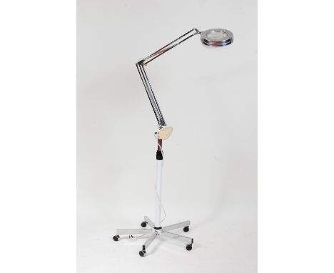 *A 1970s chrome freestanding portable medical examination lamp, with upper rotating and hinged adjustable action to a five sp