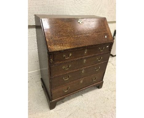 A 19th Century oak bureau, the plain top over a sloping fall enclosing a basic fitted interior over four long graduated drawe
