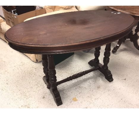 A Victorian mahogany oval centre table on twin turned end pillar supports to splayed feet (probably a ship's table as feet ha