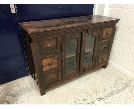A modern teak sideboard with two glazed doors flanked by two banks of three drawers, a reproduction cross banded demi-lune si