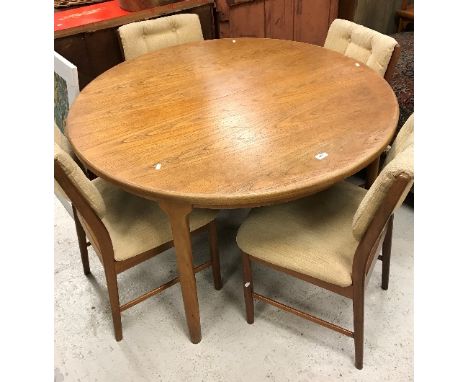 A G Plan style teak circular extending dining table on rounded supports by Mackintosh, 122 cm diameter, together with a set o