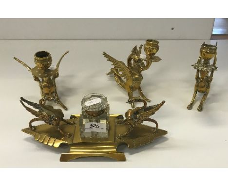 A pair of brass wyvern candlesticks, another similar candlestick and similar inkwell, 10 cm 