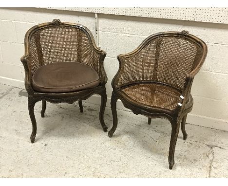 A near matching pair of circa 1900 stained beech and caned elbow chairs in the Louis XV taste, raised on cabriole legs to scr