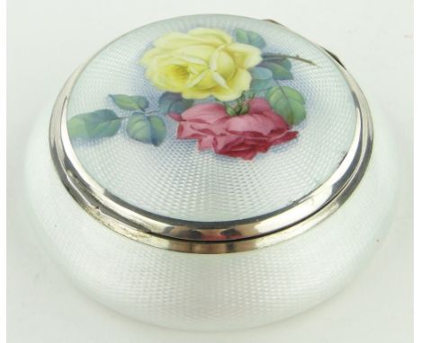 A fine quality continental silver and enamel box of circular form,
the hinged lid having painted rose design, continental hal