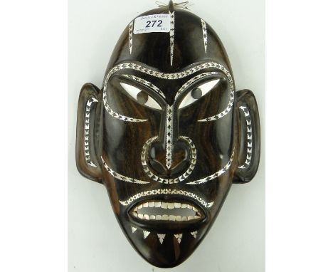 A Solomon Islands hardwood mask
with inlaid mother of pearl, 10.25".