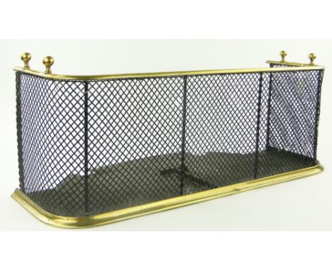 A brass framed wire mesh fender.